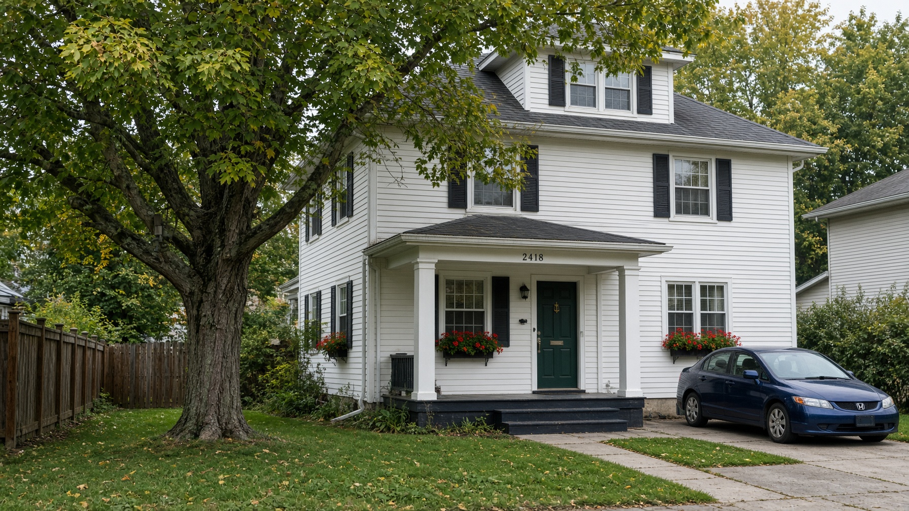 Same Green Bay colonial with a large maple over the roof and gutters